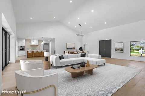 a living room with furniture and a view of kitchen
