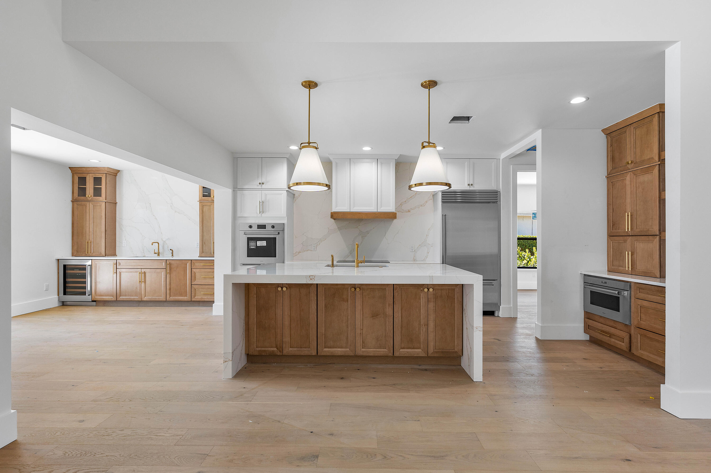 7536 Fenwick Place Boca Raton, FL 33496 - Photo 4 of 31 a large kitchen with kitchen island a stove a sink a refrigerator and a granite counter tops