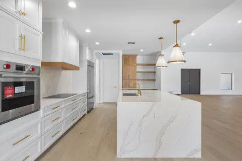 a open kitchen view white cabinets and stainless steel appliances