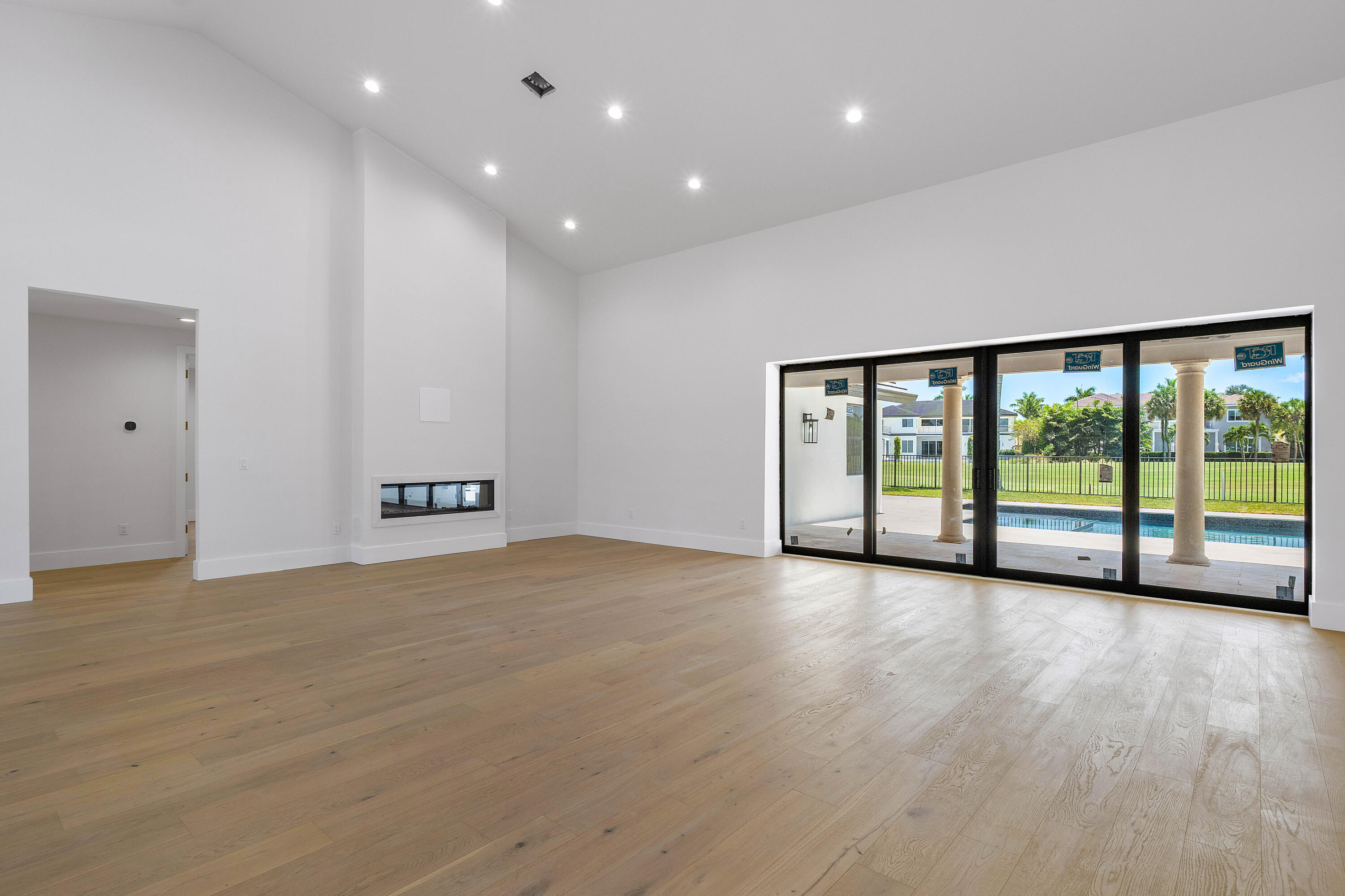 7536 Fenwick Place Boca Raton, FL 33496 - Photo 10 of 31 a view of an empty room with wooden floor and a window