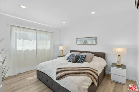 a bedroom with a large bed and a lamp