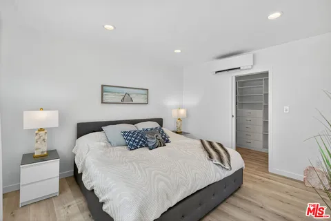 a bedroom with a bed and a lamp