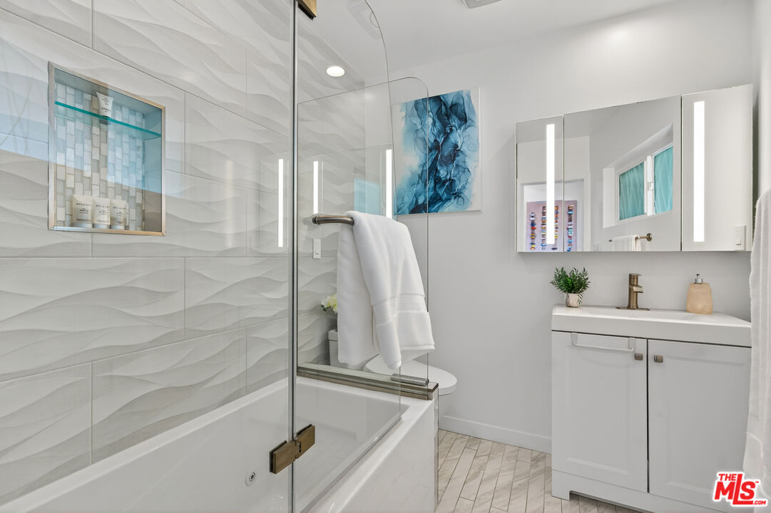 1333 14th Street, Unit 8 Santa Monica, CA 90404 - Photo 17 of 27 a bathroom with a sink and mirror with bathtub