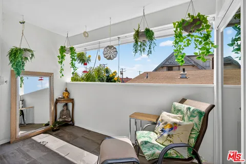 a view of room with furniture and a potted plant