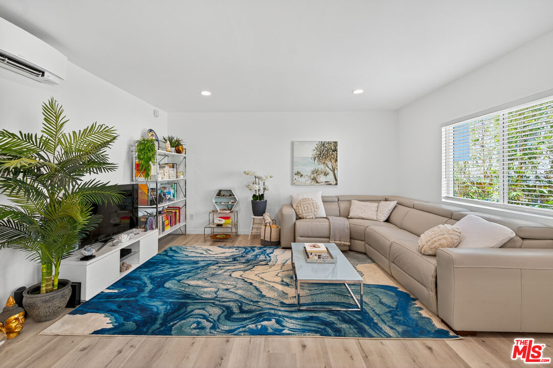 1333 14th Street, Unit 8 Santa Monica, CA 90404 - Photo 3 of 27 a living room with furniture and a flat screen tv