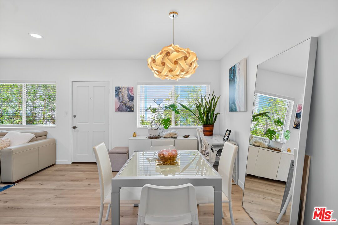 1333 14th Street, Unit 8 Santa Monica, CA 90404 - Photo 6 of 27 a dining room with furniture potted plants and wooden floor