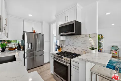 a kitchen with a refrigerator stove and microwave