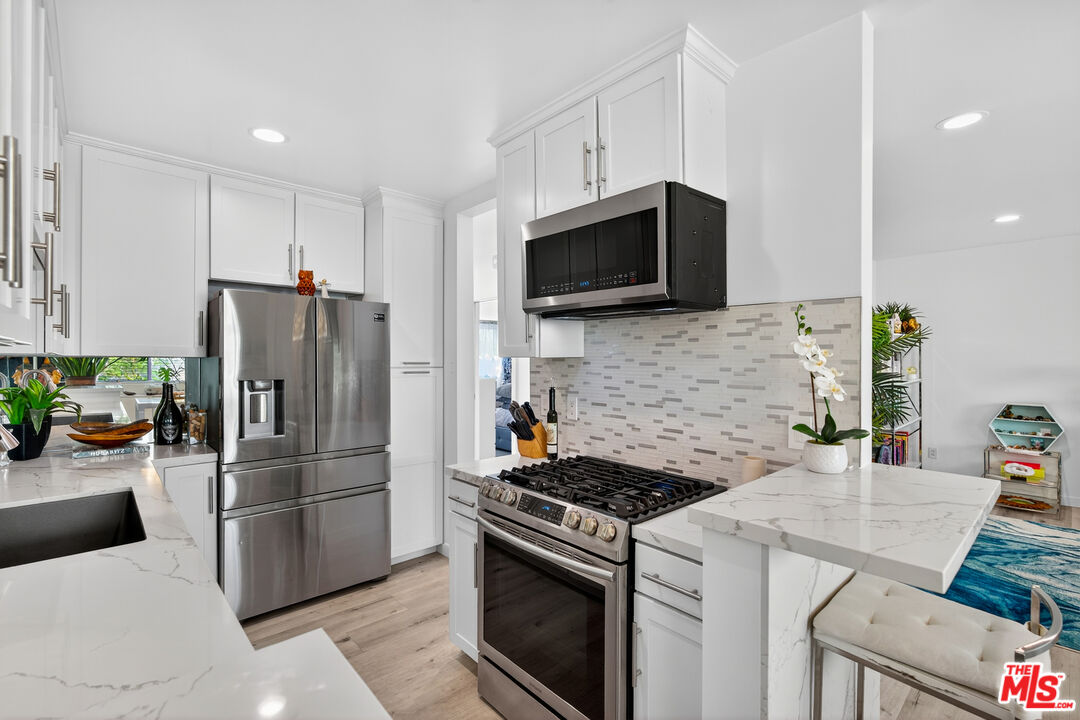 1333 14th Street, Unit 8 Santa Monica, CA 90404 - Photo 9 of 27 a kitchen with a refrigerator stove and microwave
