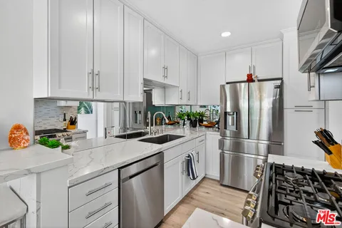 a kitchen with a sink appliances and cabinets