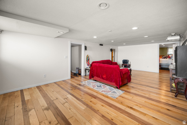 3233 Jean Street Magna, UT 84044 - Photo 19 of 33 Spacious room featuring wood flooring, recessed lighting, and white walls