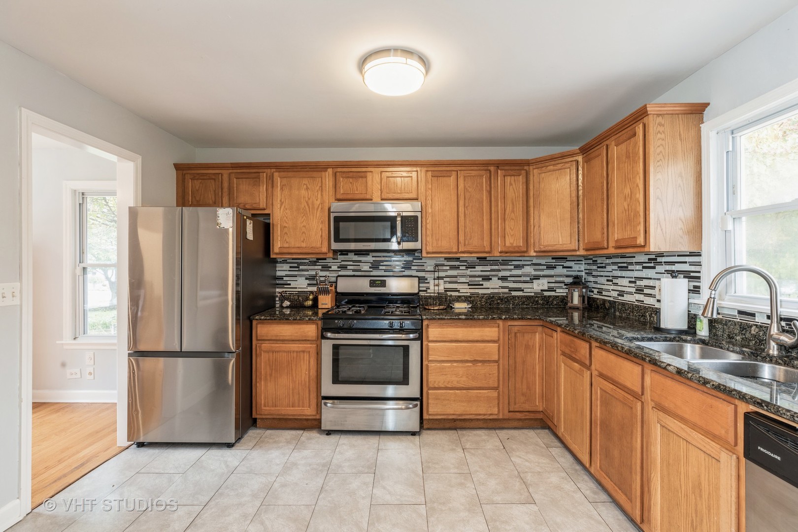 1469 Burr Oak Road Homewood, IL 60430 - Photo 6 of 24 a kitchen with stainless steel appliances granite countertop a refrigerator stove a sink dishwasher and microwave