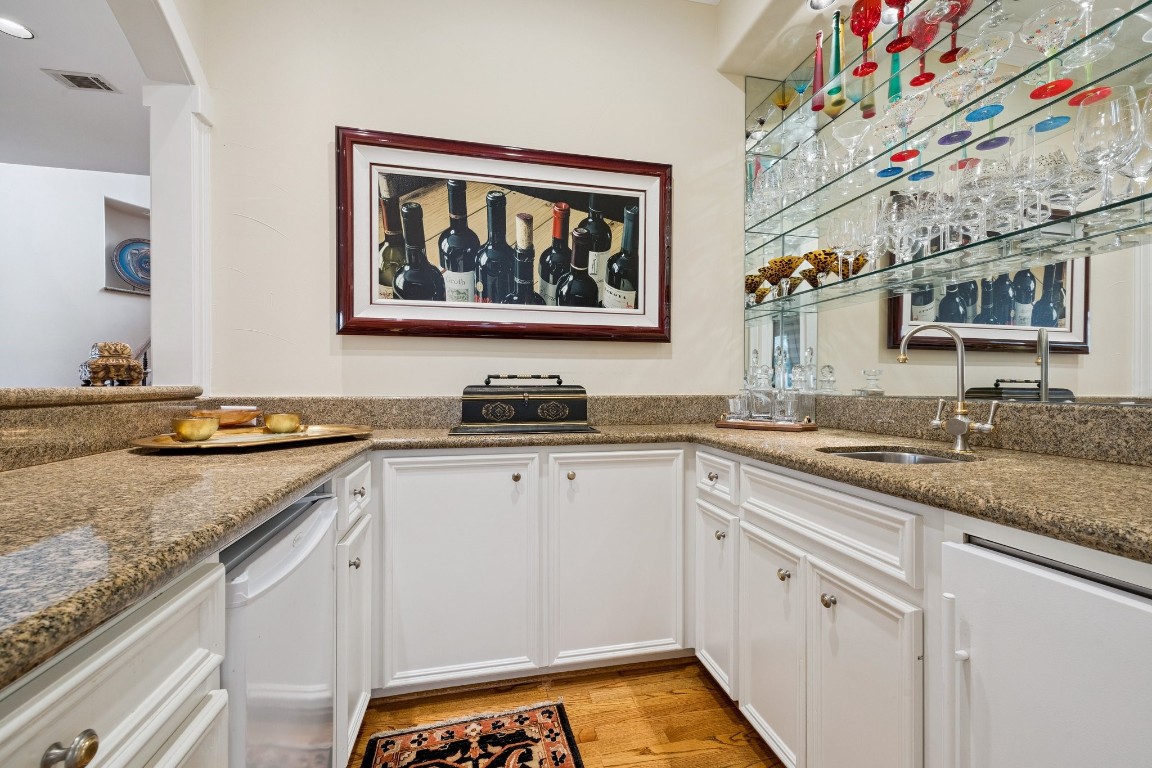 2309 Shakespeare Street Houston, TX 77030 - Photo 14 of 48 a white kitchen with granite countertop a sink and dishwasher stove top oven
