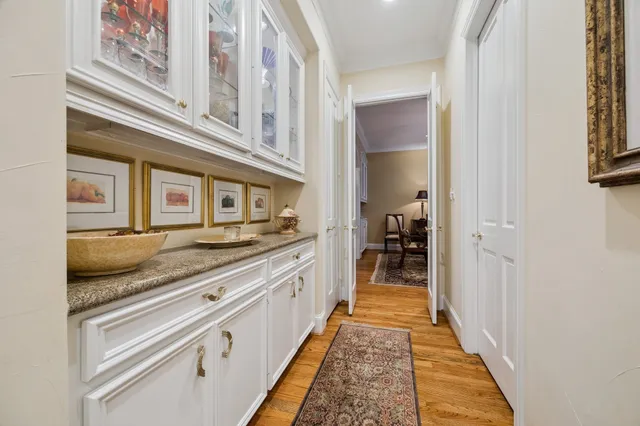 a en suite bathroom with a granite countertop sink and a mirror