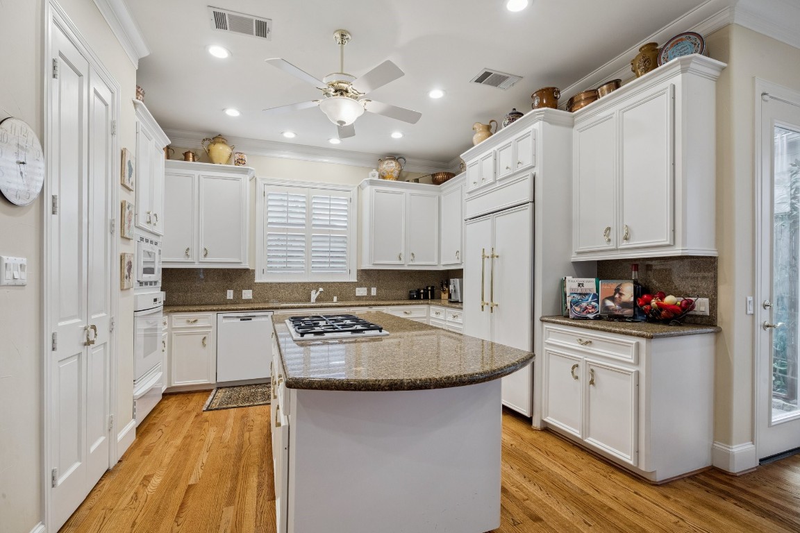 2309 Shakespeare Street Houston, TX 77030 - Photo 16 of 48 a kitchen with a refrigerator a sink and dishwasher with wooden floor