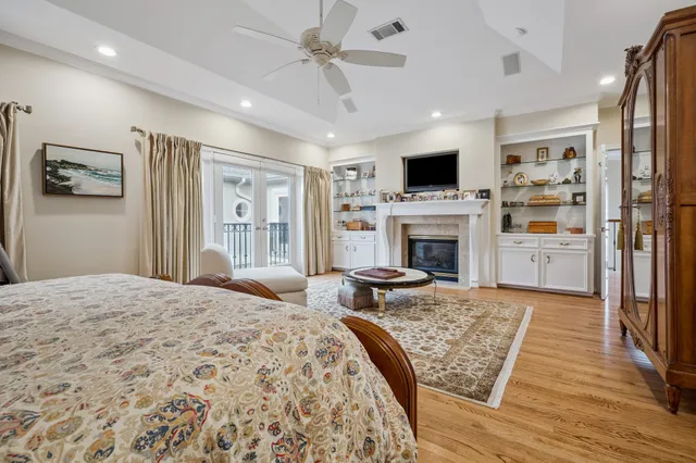 a bedroom with furniture fireplace and flat screen tv