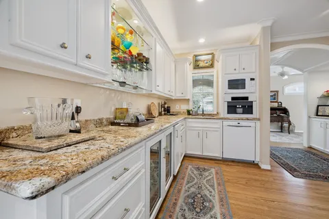 a kitchen with stainless steel appliances granite countertop a sink and cabinets