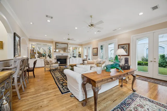 a living room with fireplace furniture and a wooden floor