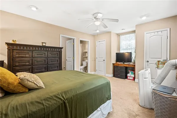 a bedroom with a bed and flat screen tv