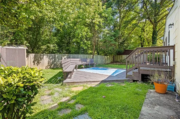 a view of a yard with furniture and a garden