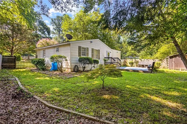 a backyard of a house with table and chairs