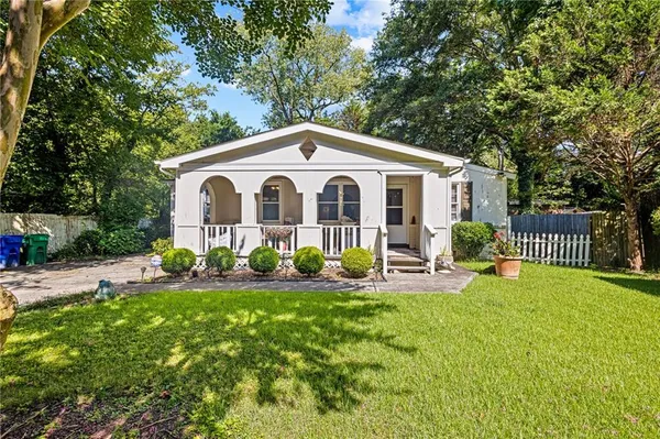 a front view of a house with patio and garden