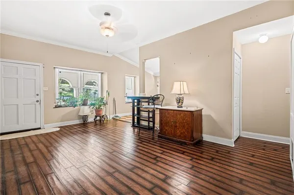 a living room with furniture and wooden floor