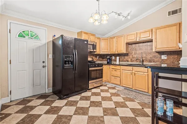 a kitchen with stainless steel appliances granite countertop a refrigerator and a sink