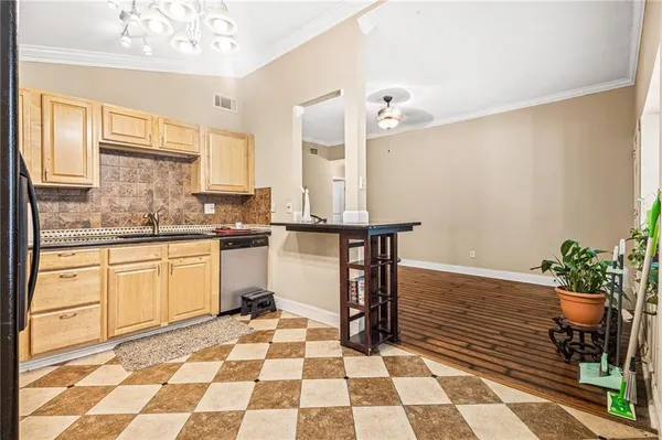 a kitchen with a sink a counter and cabinets