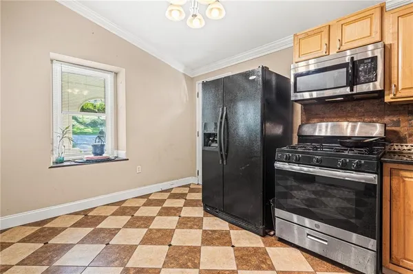 a metallic refrigerator freezer sitting in a kitchen