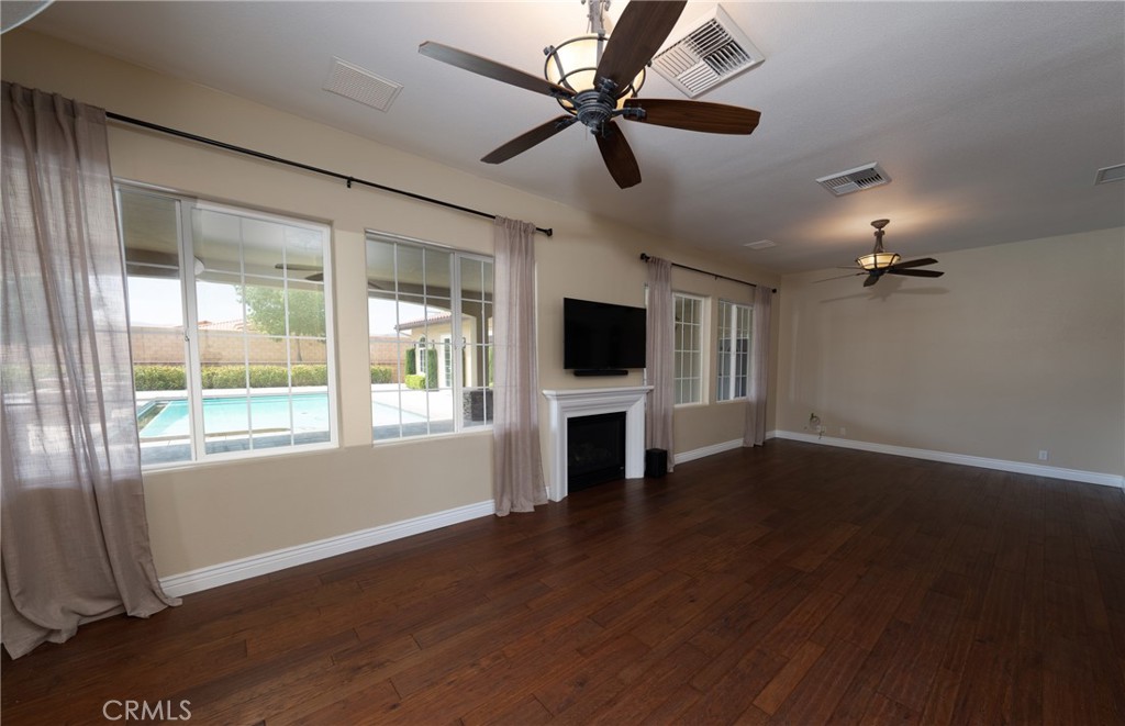 125 West Franklin Avenue Ridgecrest, CA 93555 - Photo 15 of 32 a view of a livingroom with a flat screen tv ceiling fan and hardwood floor