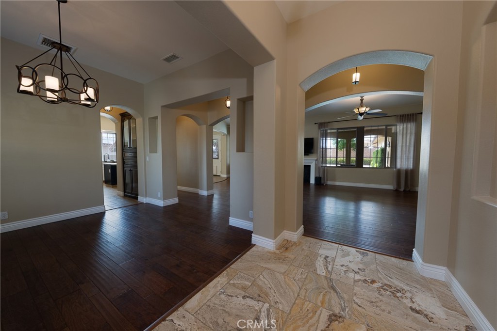 125 West Franklin Avenue Ridgecrest, CA 93555 - Photo 5 of 32 a view of a hallway with wooden floor and a chandelier