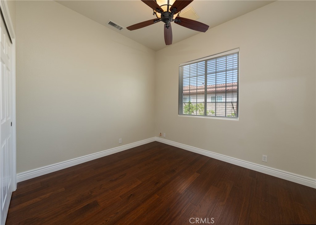 125 West Franklin Avenue Ridgecrest, CA 93555 - Photo 9 of 32 an empty room with wooden floor fan and windows