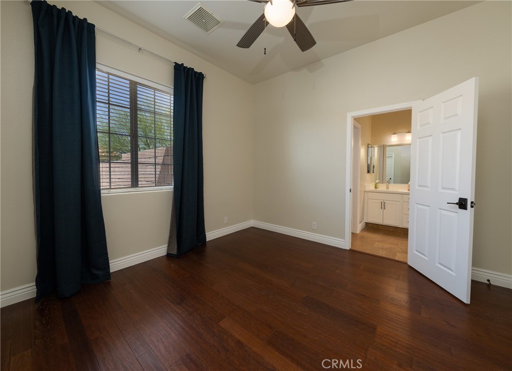 125 West Franklin Avenue Ridgecrest, CA 93555 - Photo 10 of 32 an empty room with wooden floor and windows
