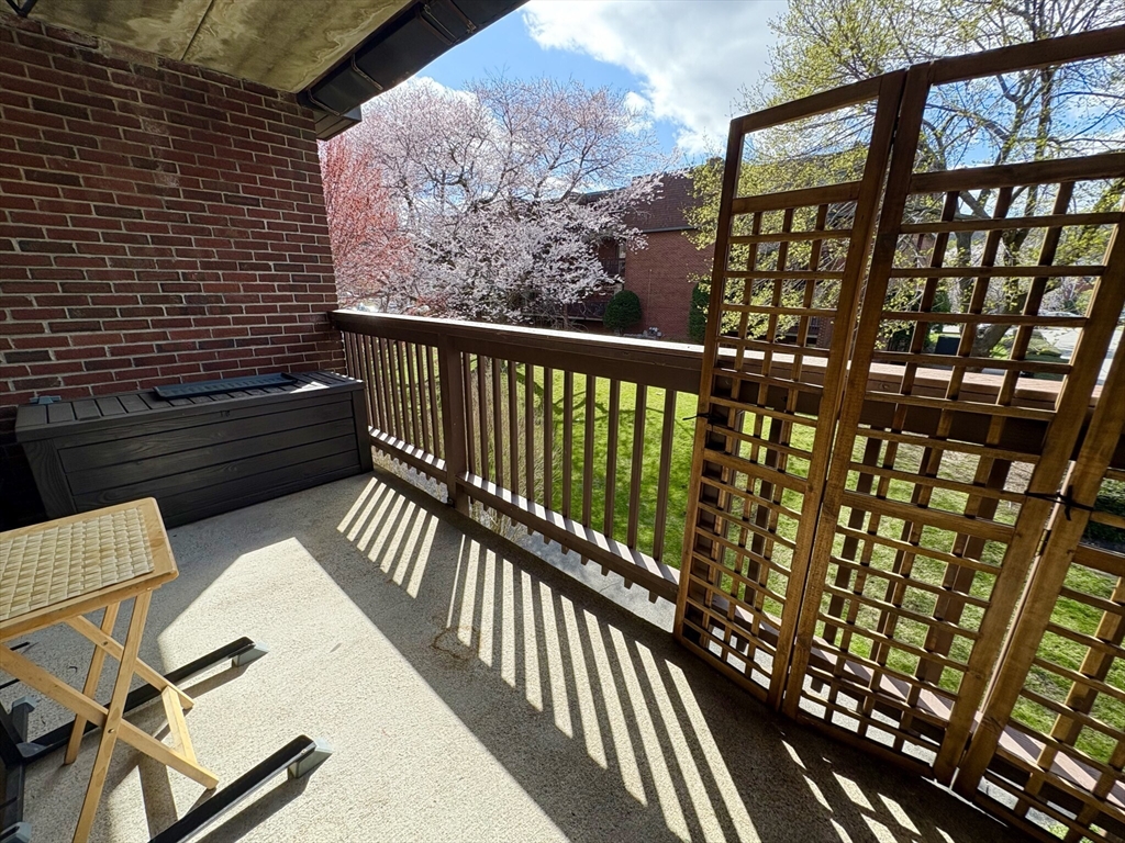 140 Kenrick Street, Unit 21 Boston, MA 02135 - Photo 22 of 36 a view of balcony with wooden floor