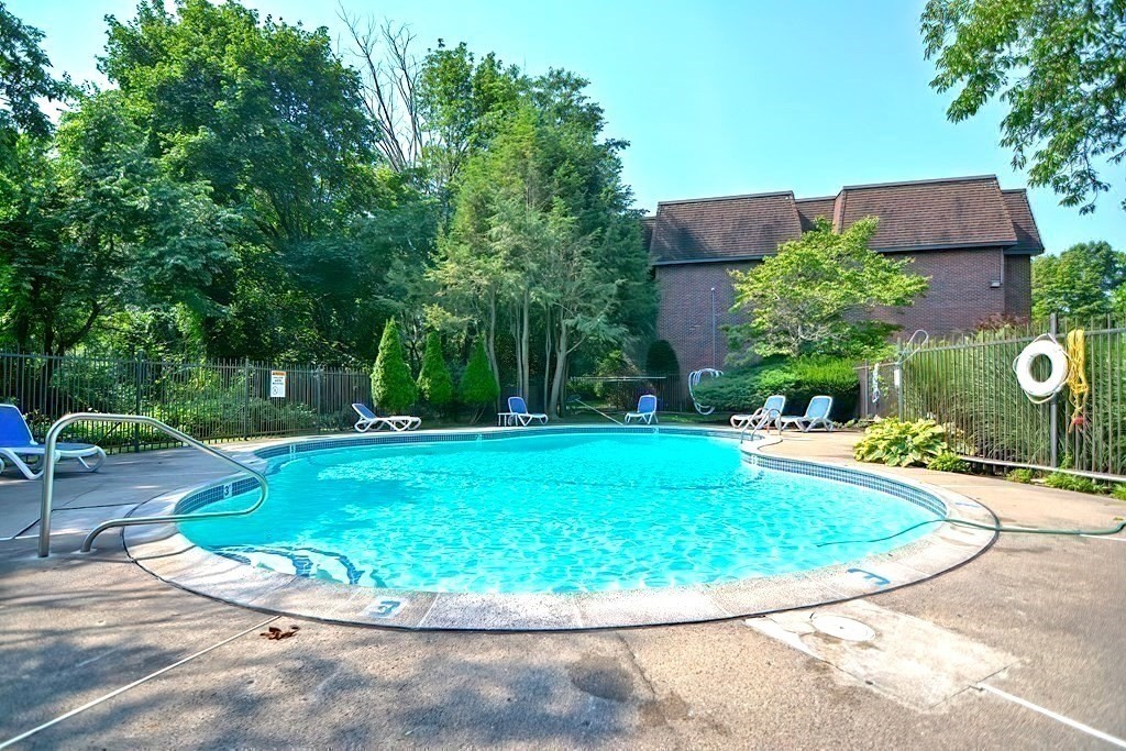 140 Kenrick Street, Unit 21 Boston, MA 02135 - Photo 26 of 36 a view of a swimming pool with a patio