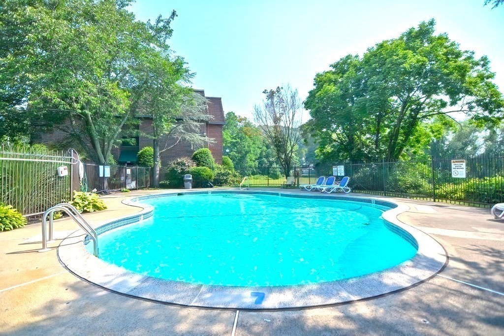 140 Kenrick Street, Unit 21 Boston, MA 02135 - Photo 27 of 36 a view of a swimming pool with a patio