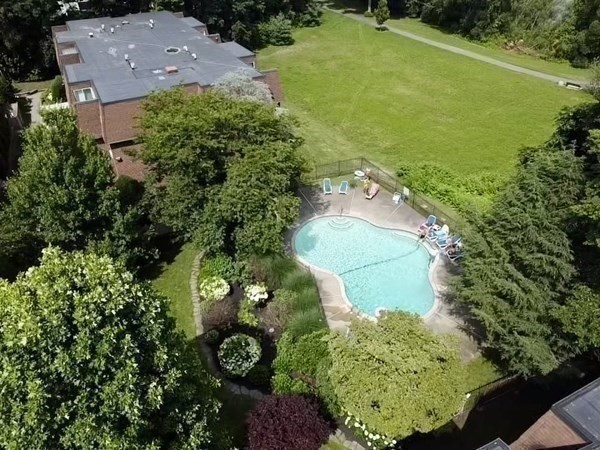 140 Kenrick Street, Unit 21 Boston, MA 02135 - Photo 28 of 36 an aerial view of a house with a yard and lake view