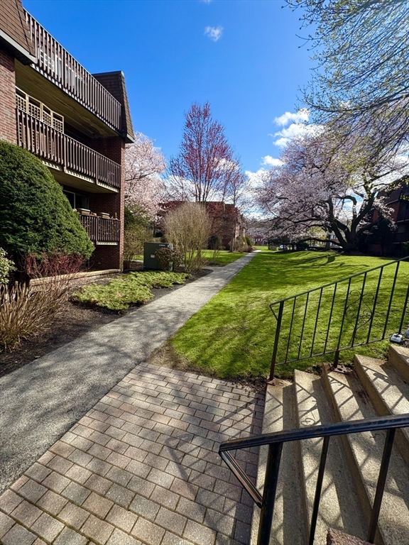 140 Kenrick Street, Unit 21 Boston, MA 02135 - Photo 34 of 36 a view of a chairs and table in the patio