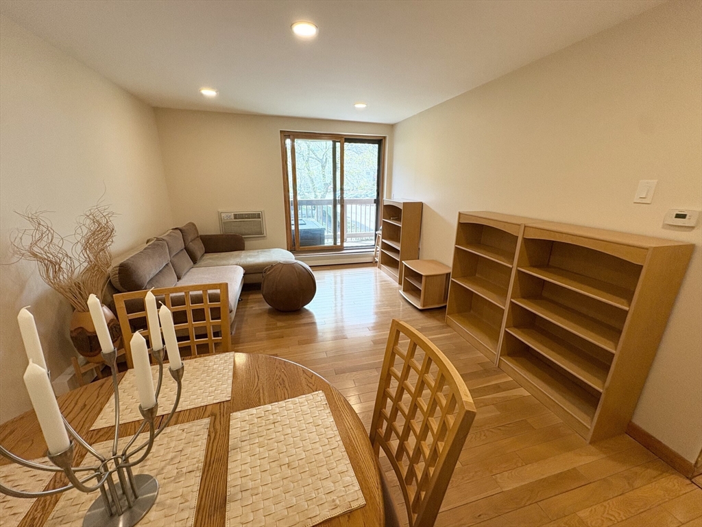 140 Kenrick Street, Unit 21 Boston, MA 02135 - Photo 5 of 36 a view of a livingroom with furniture and windows