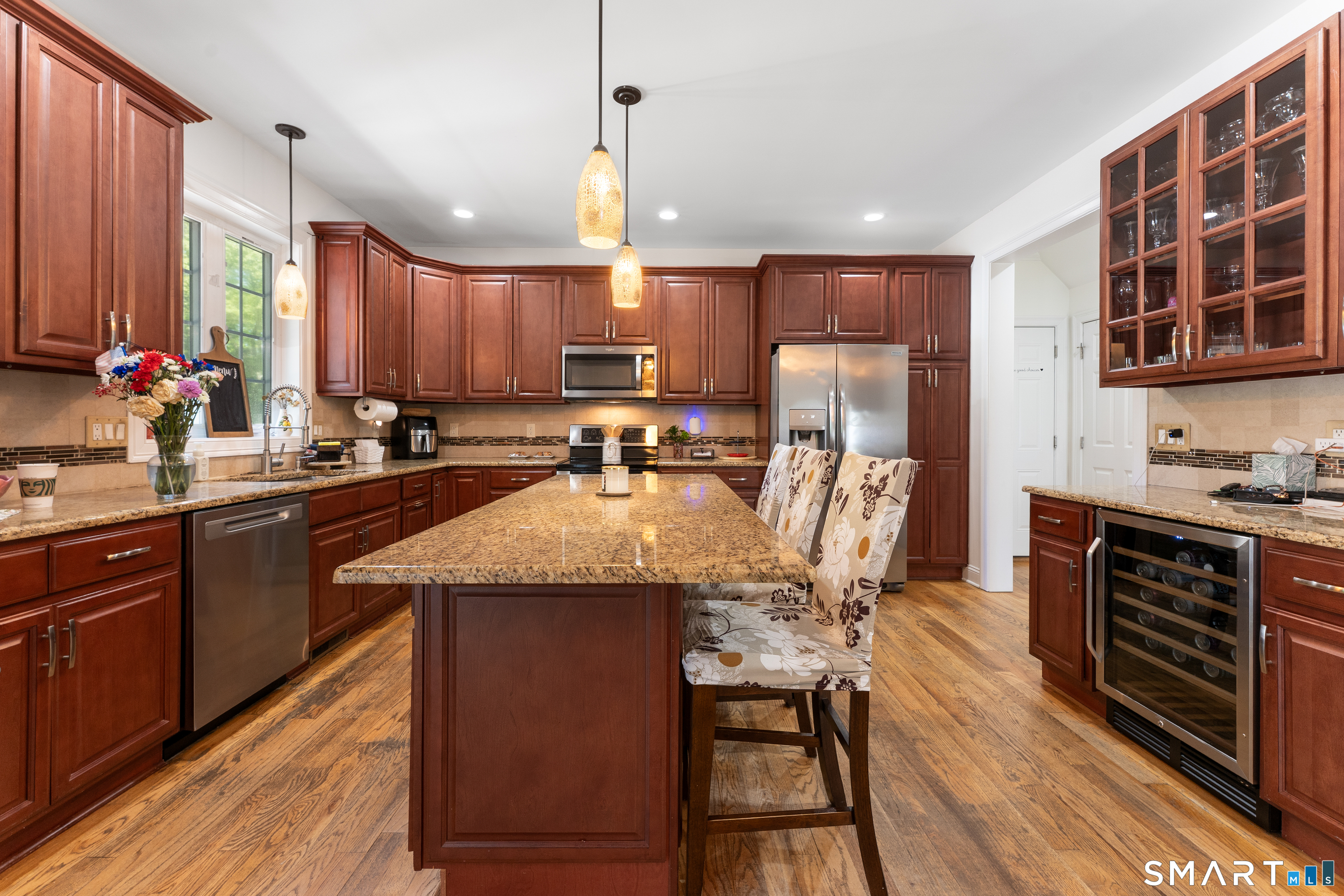 261 Spring Road North Haven, CT 06473 - Photo 16 of 39 a kitchen with a table chairs sink microwave and cabinets