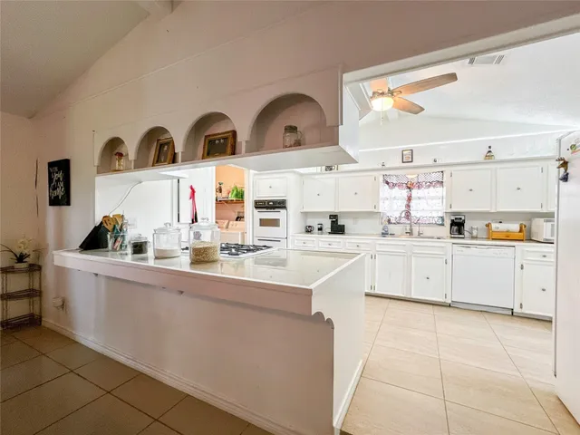 a kitchen with stainless steel appliances a sink and cabinets