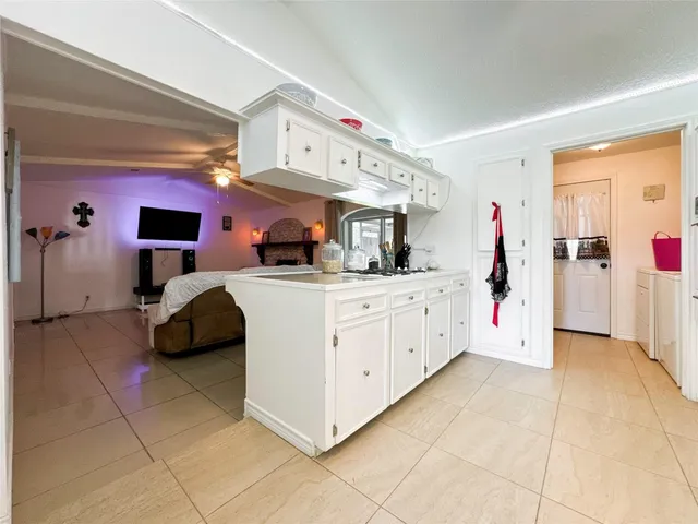 a kitchen with stainless steel appliances kitchen island granite countertop a sink and cabinets