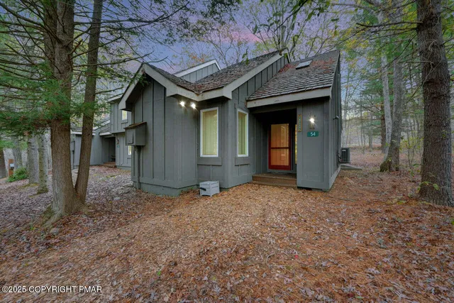 a view of a house with a yard and tree