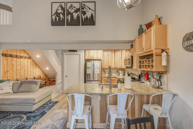 a dining room with furniture and a large window