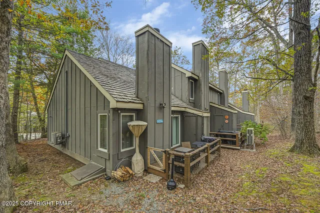 a view of a house with a yard and wooden fence