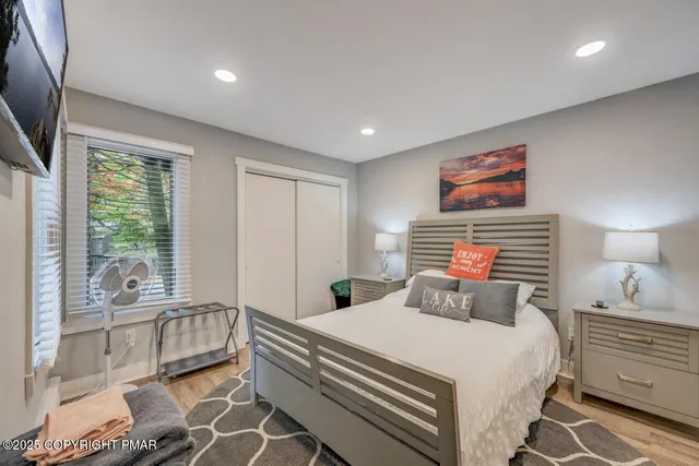 a bedroom with a large bed and a large window