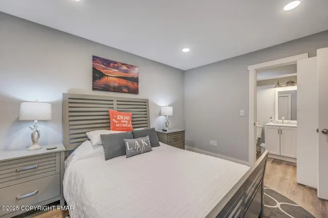 a bedroom with a bed and a painting on the wall