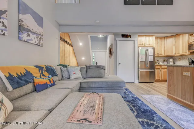 a living room with furniture and wooden floor