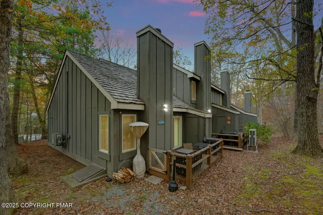 a view of a house with a yard and wooden fence