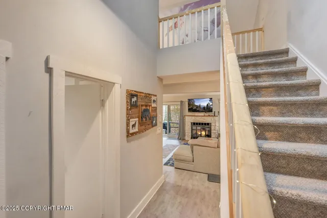 a view of a hallway with wooden floor and entryway